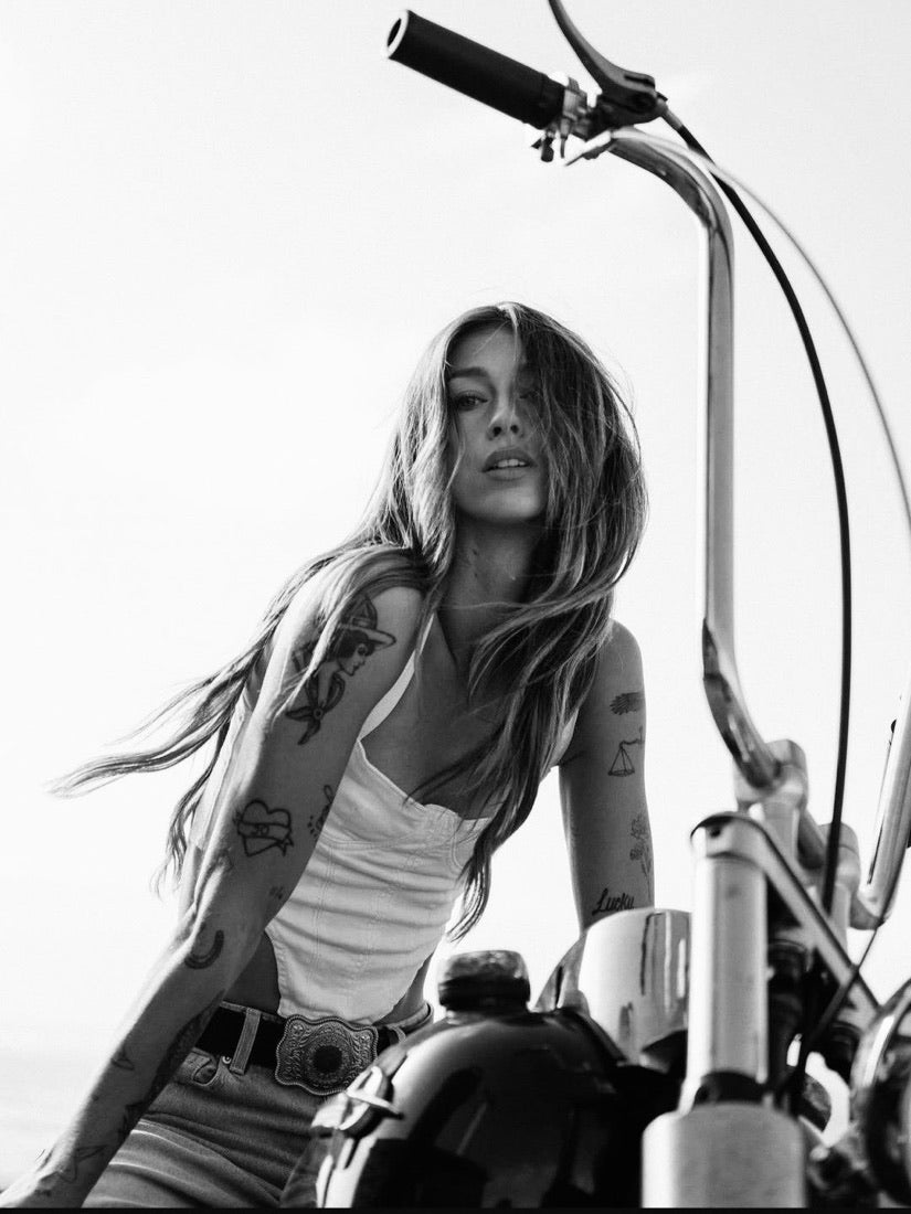 Female rider, chopper handlebars, belt buckle